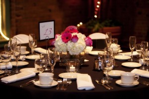 Hot pink gerbera daisy and roses with white hydrangea centerpiece